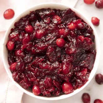 Freshly made cranberry sauce in a white bowl.