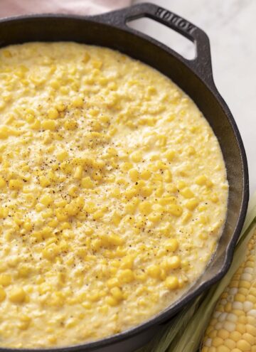 Creamed corn in a cast iron skillet.
