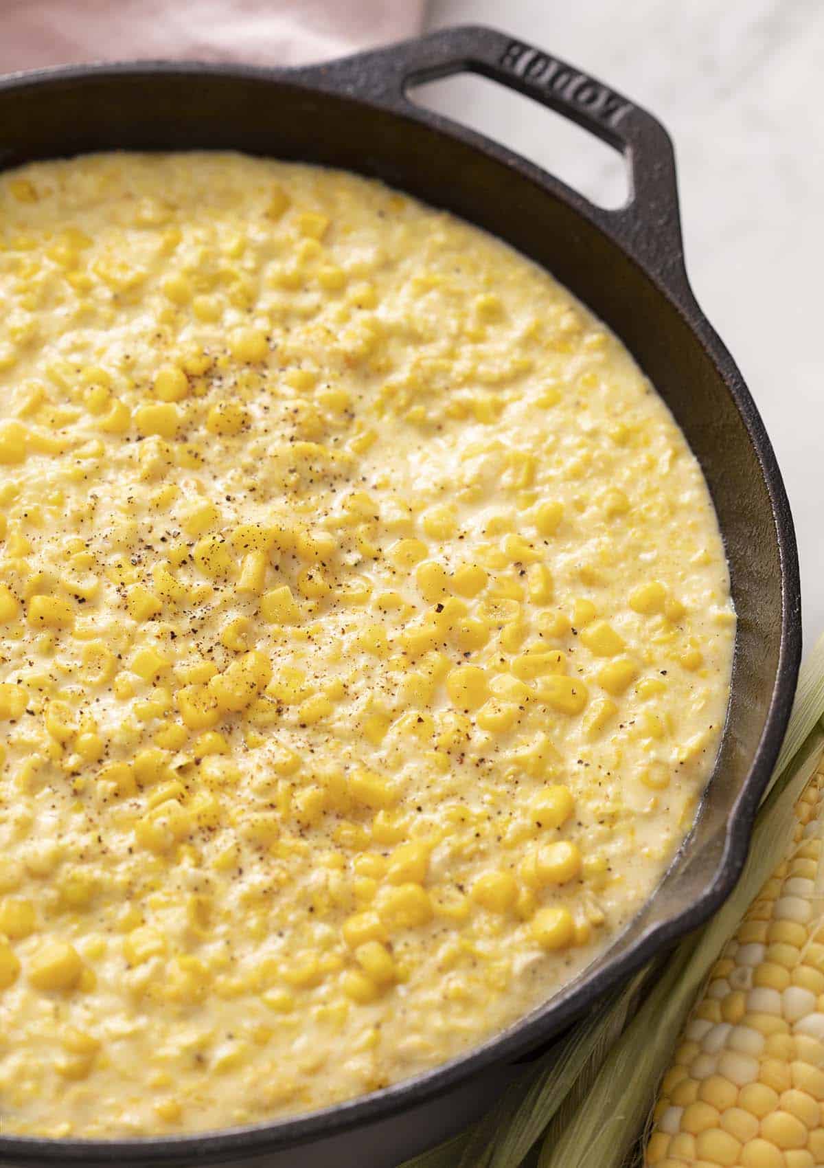 Creamed corn in a cast iron skillet.