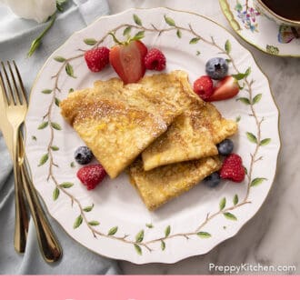 folded crepes on a plate with berries
