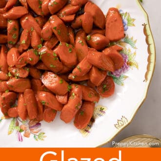 Glazed carrotsgarnished with parsley in a serving bowl.