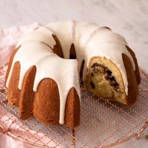 A sock it to me cake on a copper cooling rack.