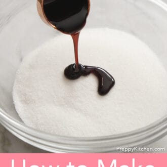 molasses being poured over white sugar in a glass bowl