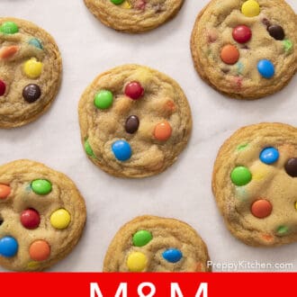 M&M cookies arranged on a sheet of parchment paper.