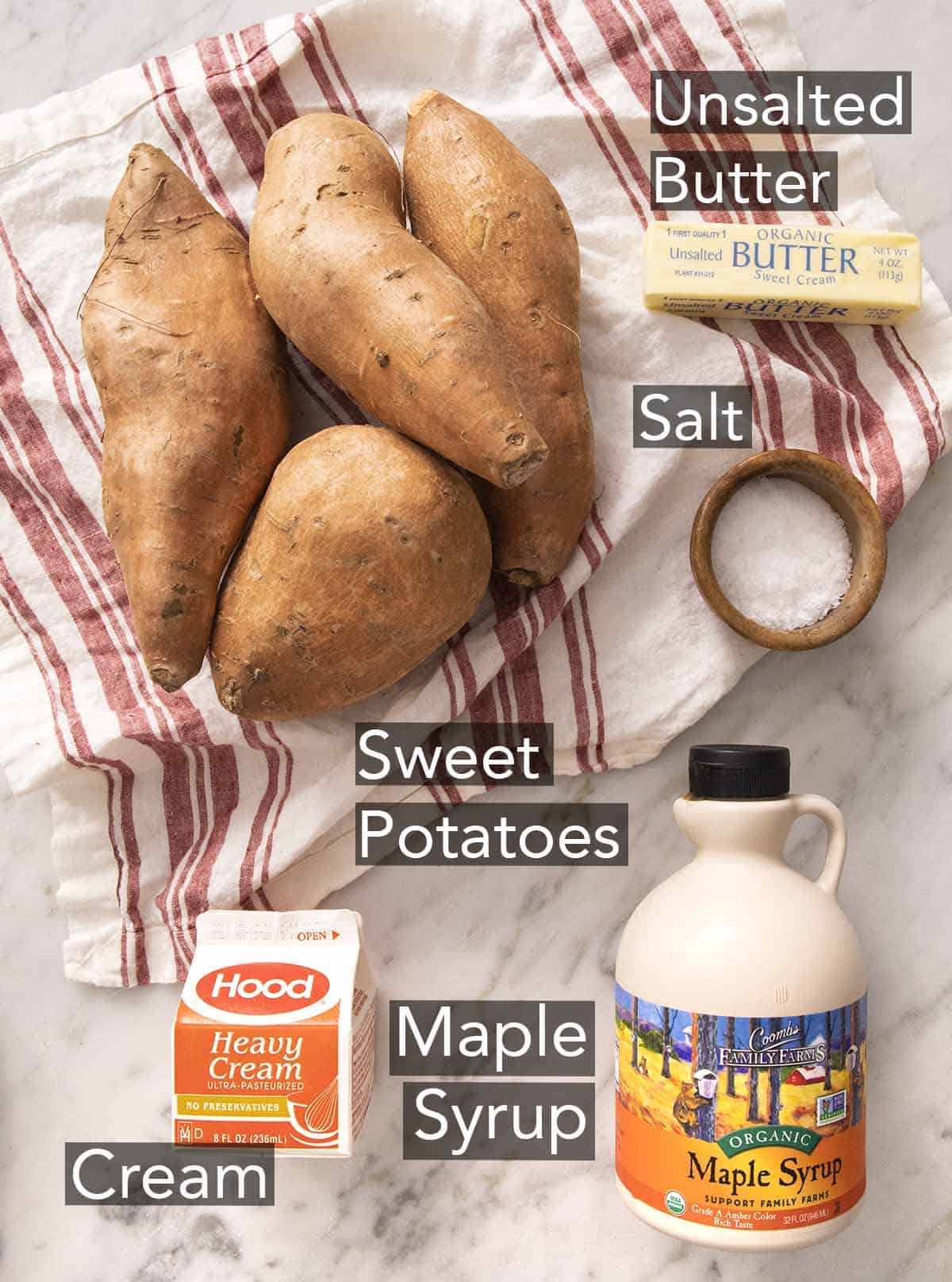 Ingredients to make mashed sweet potatoes on a marble counter.