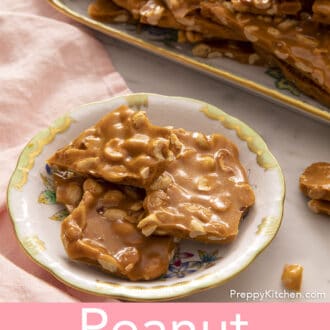 pieces of peanut brittle stacked on a floral plate