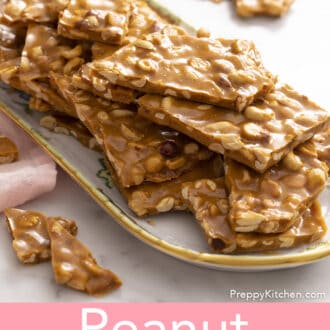 pieces of peanut brittle stacked on a porcelain serving tray