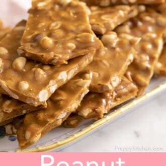 close up of pieces of peanut brittle stacked on a floral plate
