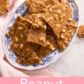 pieces of peanut brittle stacked on a blue and white platter