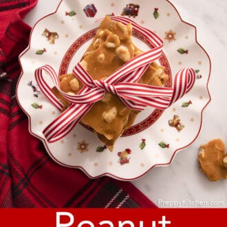 overhead photo of pieces of peanut brittle stacked on a christmas plate
