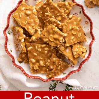 pieces of peanut brittle stacked on a christmas plate