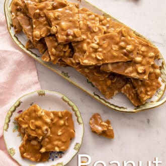 pieces of peanut brittle stacked on a floral tray