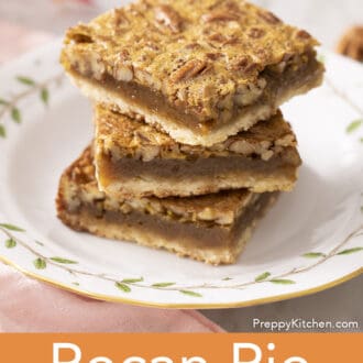 3 pecan pie bars stacked on a plate