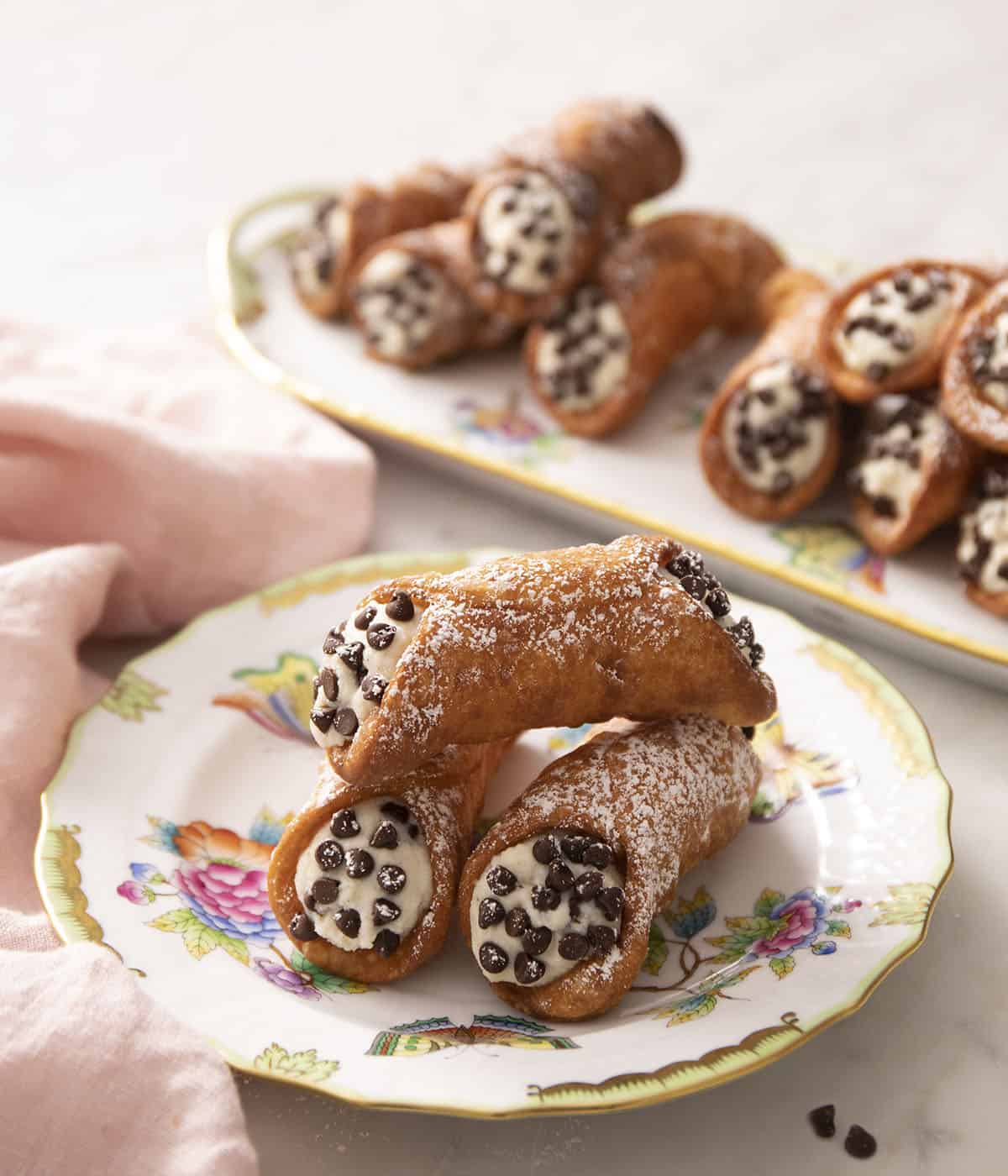 Cannoli with mini chocolate chips on a plate.