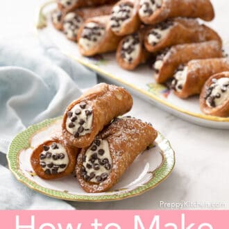 cannoli on a plate with a tray of cannoli in the background