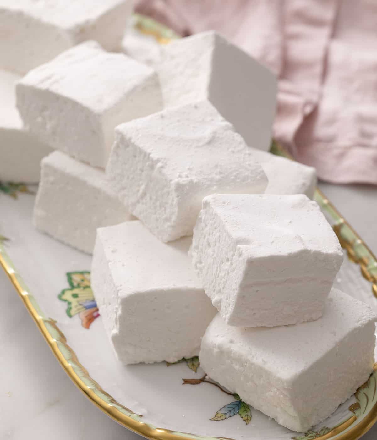 Big homemade marshmallows on a porcelain platter.
