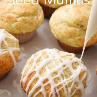 group of lemon poppy seed muffins on a piece of parchment paper