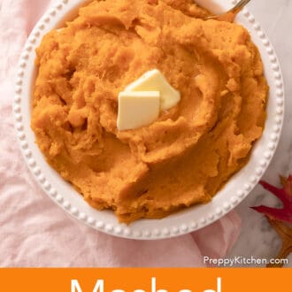 Mashed sweet potatoes with butter in a white serving dish