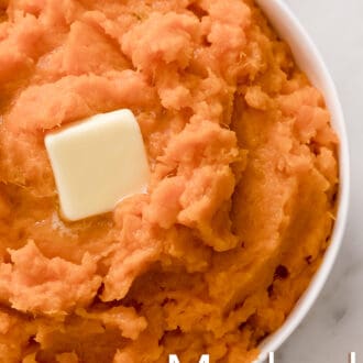 Mashed sweet potatoes with butter in a white bowl