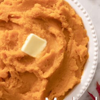 Mashed sweet potatoes with butter in a white serving dish