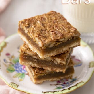 pecan pie bars stacked on a floral plate