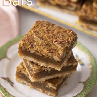 pecan pie bars stacked on a plate