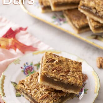 pecan pie bars stacked on a floral plate