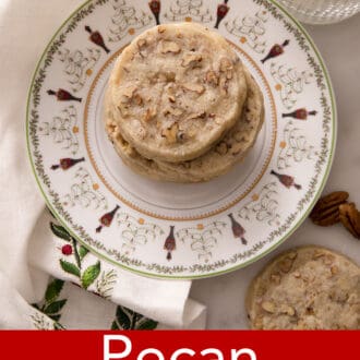 pecan sandies stacked on a christmas themed plate