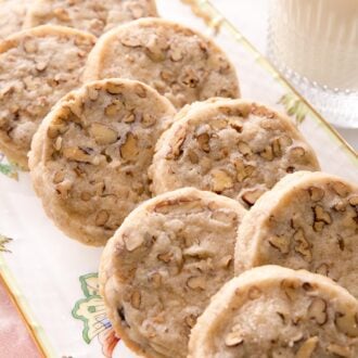 Pecan sandies arranged on a porcelain platter.