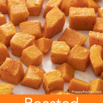 cubed roasted butternut squash spread across a baking sheet