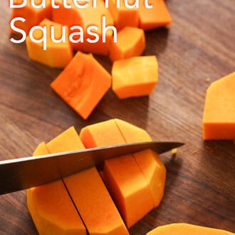 roasted butternut squash being cut on a cutting board