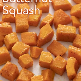 cubed roasted butternut squash spread across a baking sheet