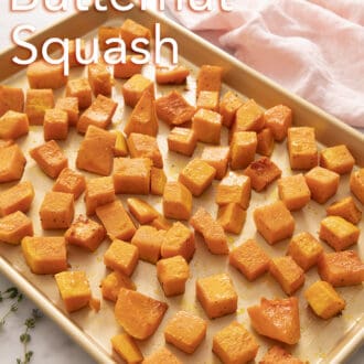 cubed roasted butternut squash spread across a baking sheet