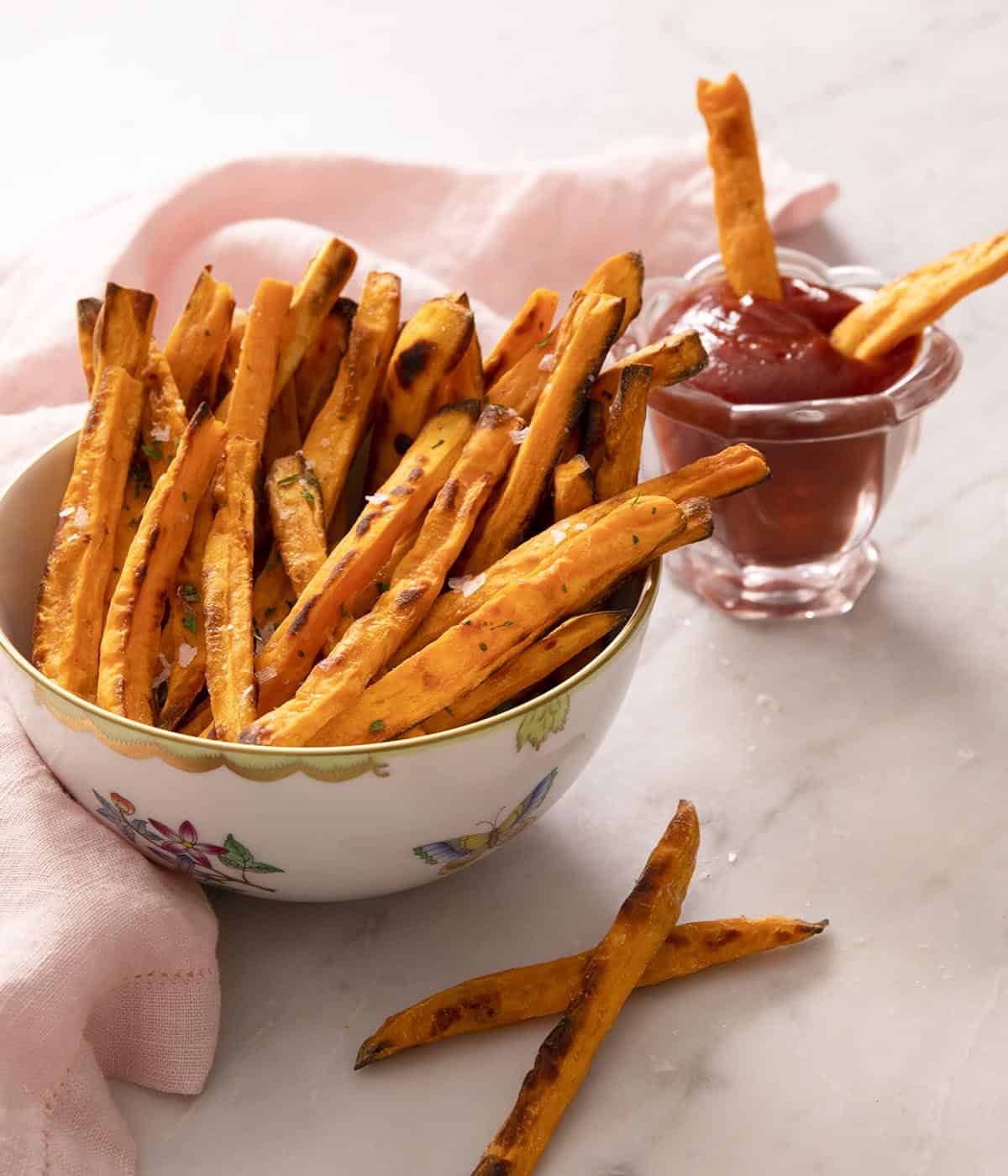A porcelain bowl of sweet potato fries.