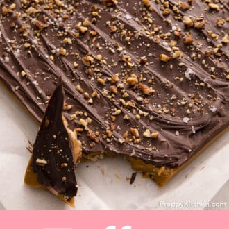 large square of toffee on a piece of parchment paper with one piece broken off