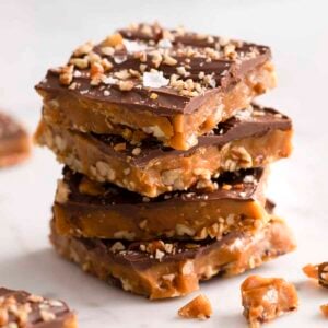 Four pieces of toffee on a marble counter.