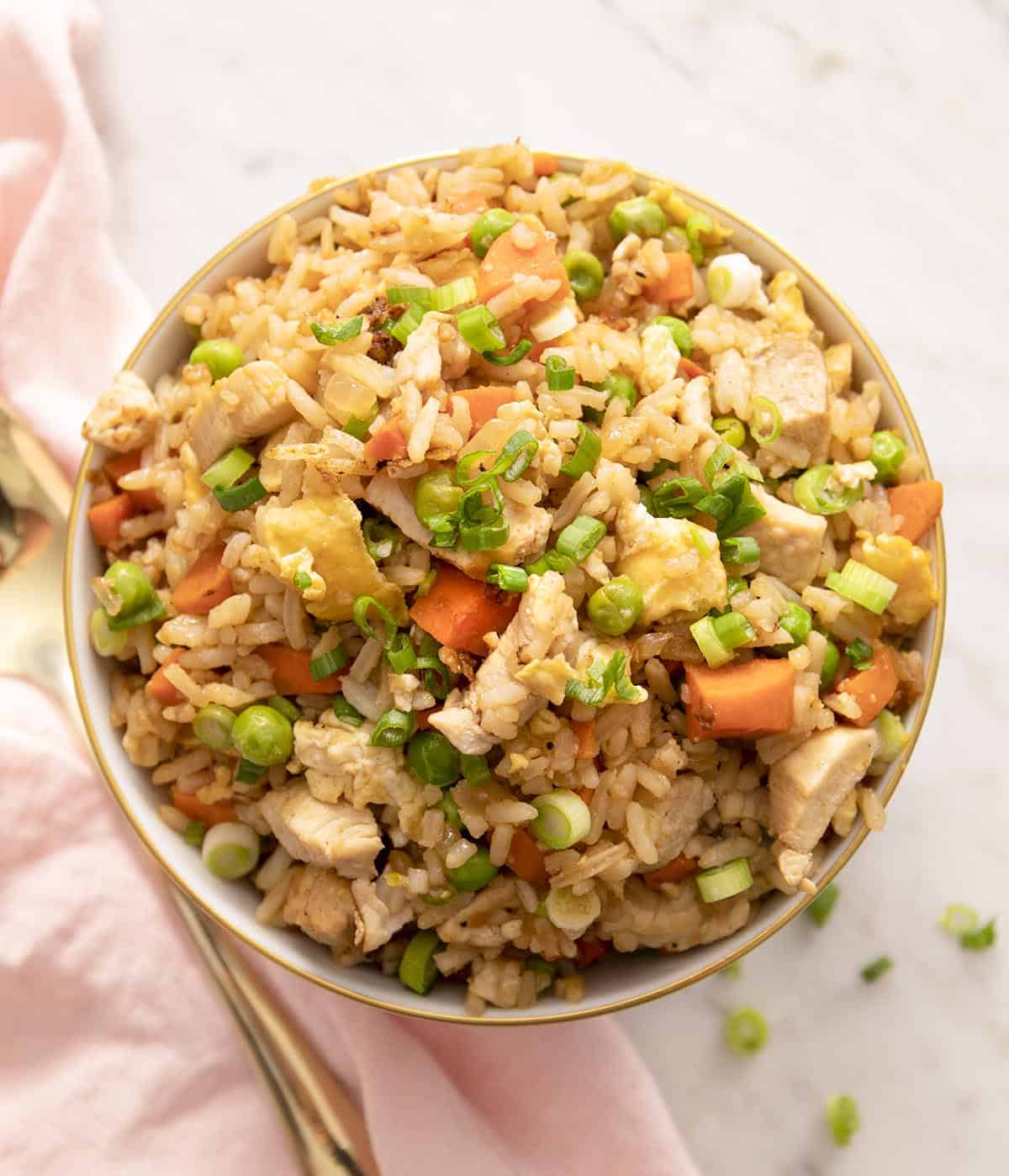 An overhead shot of a bowl of chicken fried rice