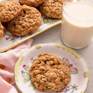 Oatmeal scotchies on plates with a glass of milk.