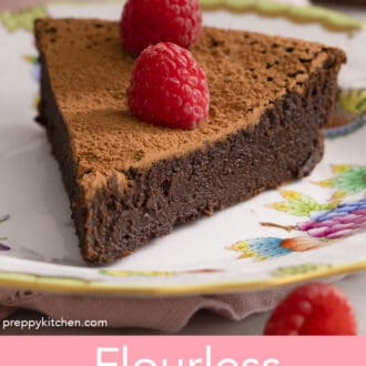 A piece of flourless chocolate cake topped with raspberries.