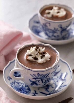 A blue china cup of hot chocolate. A second cup in the background.