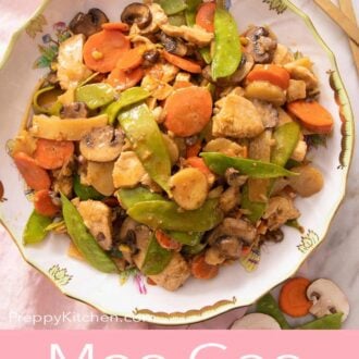 Pinterest graphic of a plate of moo goo gai pan by gold serving utensils.