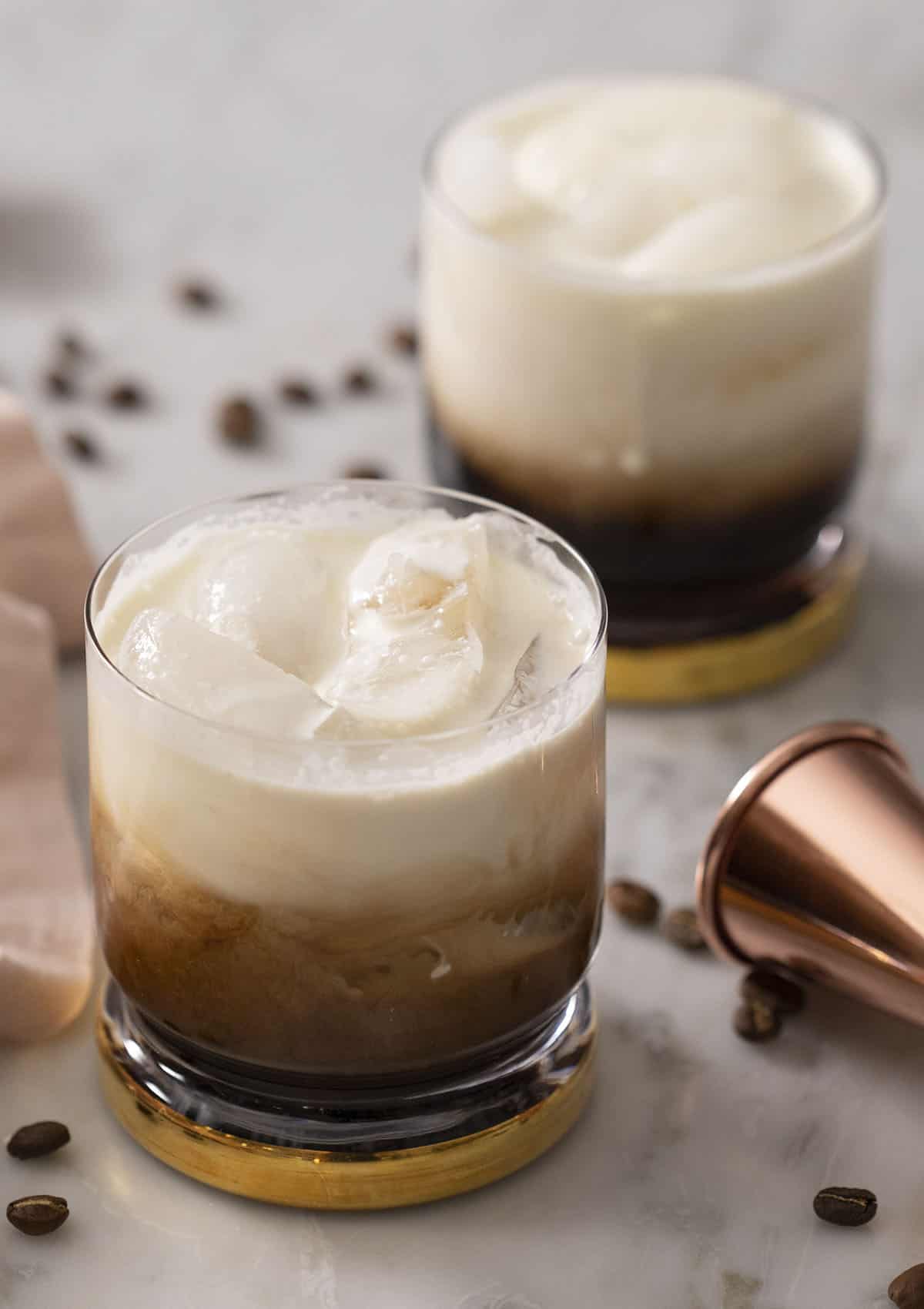 Two White Russian cocktails on a marble surface