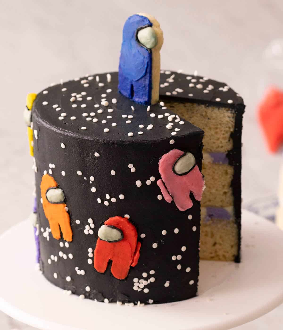 A close up of an among us cake with a slice removed