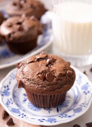 A close up of a chocolate muffin on a blue plate