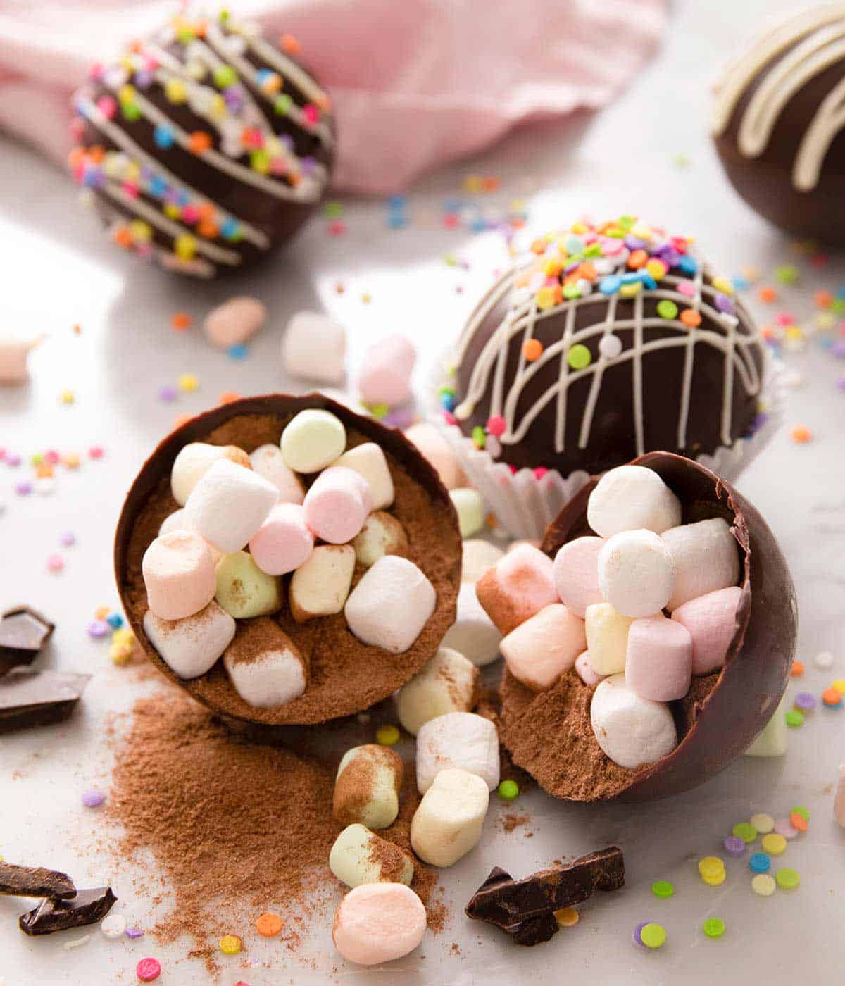 A hot chocolate bomb cut open with marshamallows and hot chocolate powder inside