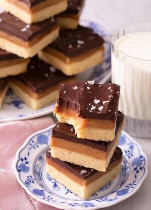 Three Millionaire's shortbread stacked on top of each other one with a bite out