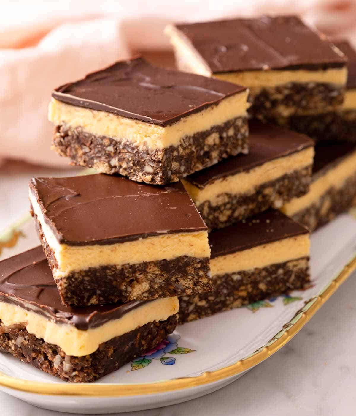 A pile of Nanaimo bars on a serving platter