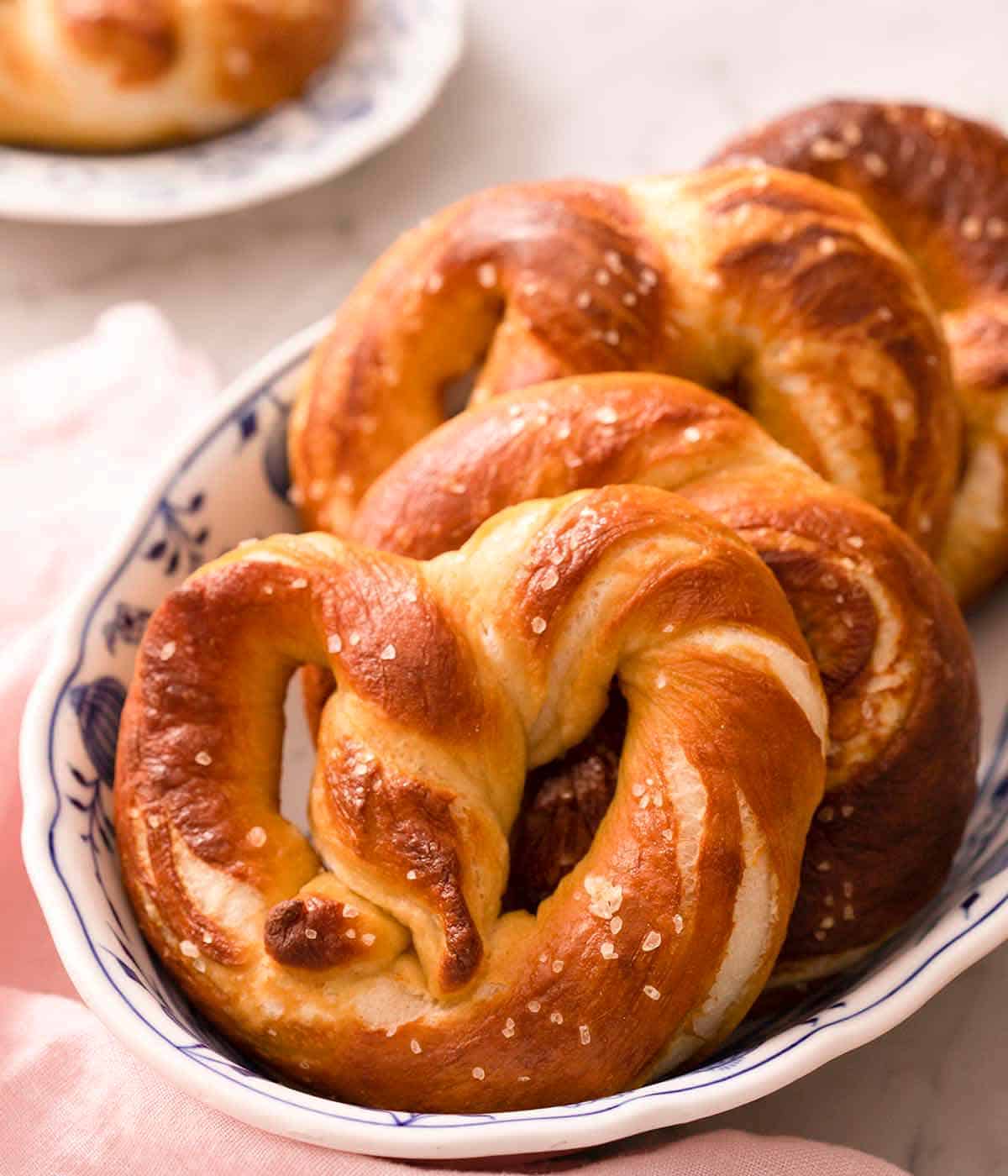 A close up of soft pretzels on a plate