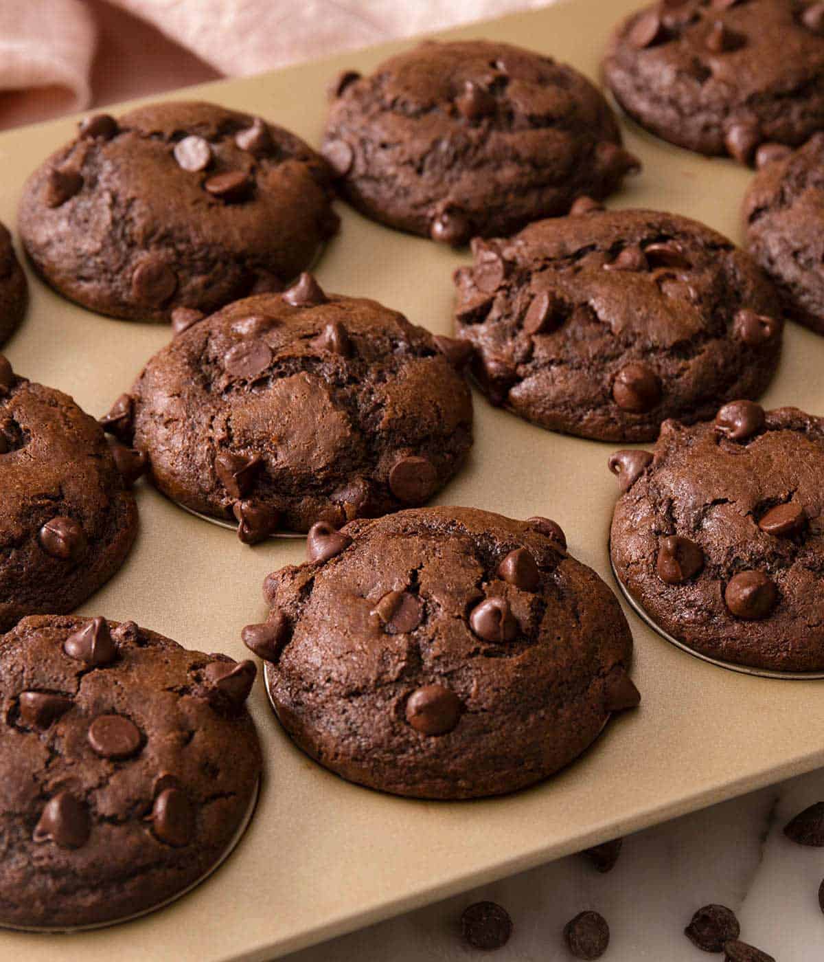A close up of baked chocolate muffins in a muffin pan