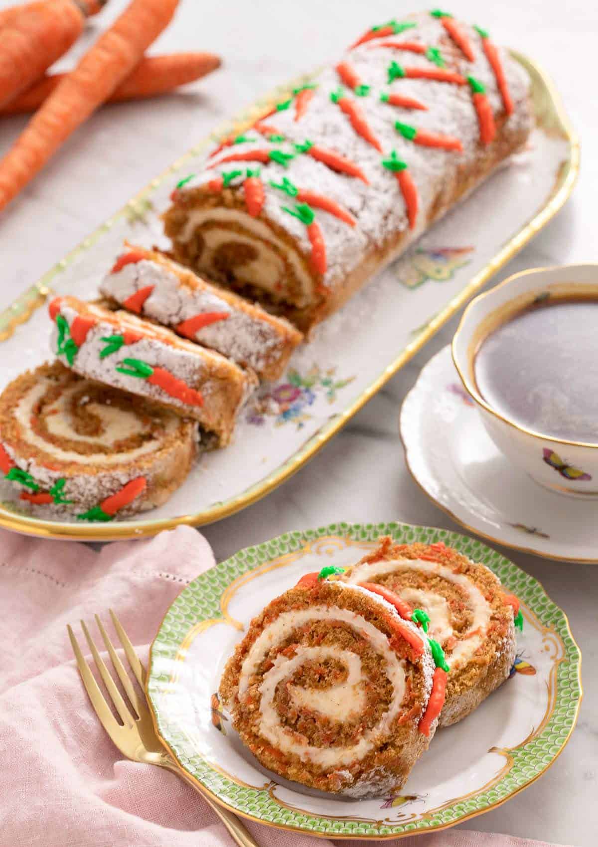 A close up of slices of a carrot cake roll on a plate